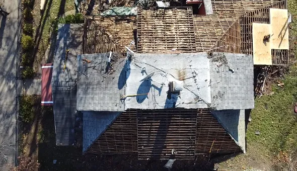 Top-down aerial photograph of a residential building’s wooden roof decking under construction in Brooklyn, NY.